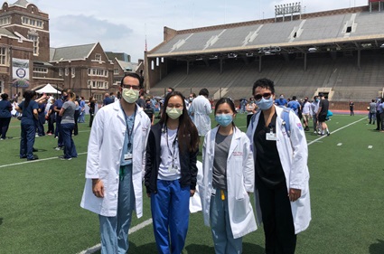 Fellows in masks on Franklin Field